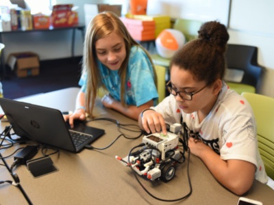 Destiny Sommer and Lydia Nystrom work with their robot
